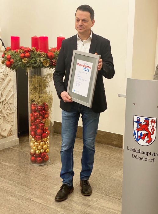 Michael Süsser hält die Urkunde zum Umweltpreis in der Hand